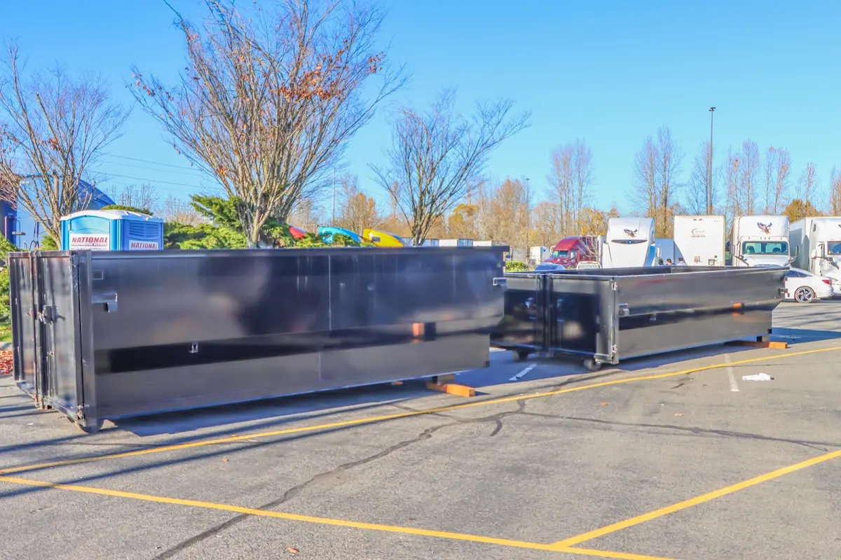 Professional dumpster rental service with roll-off container on residential driveway in Anchorage